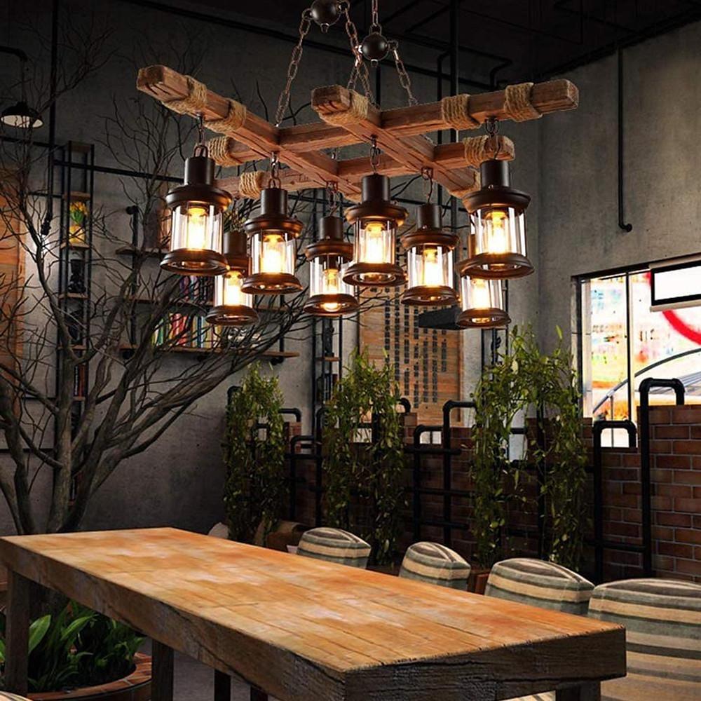 Rustic wood chandelier hanging over wooden table in loft-style interior.