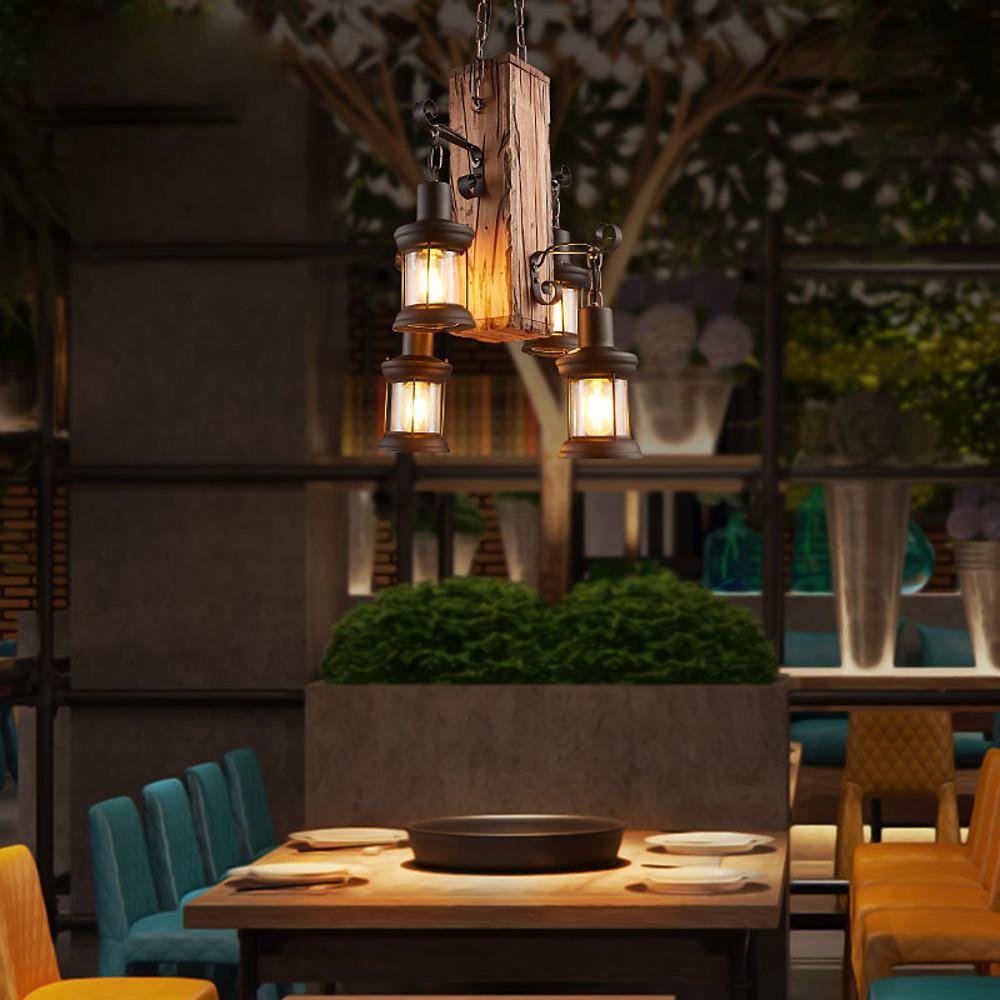 Rustic wood chandelier creating warm ambient lighting in a restaurant-style dining setting.