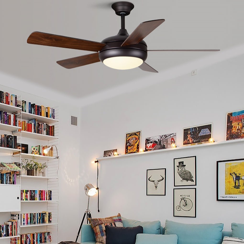 Semi-flush mount ceiling fan with light providing soft illumination in a modern study.