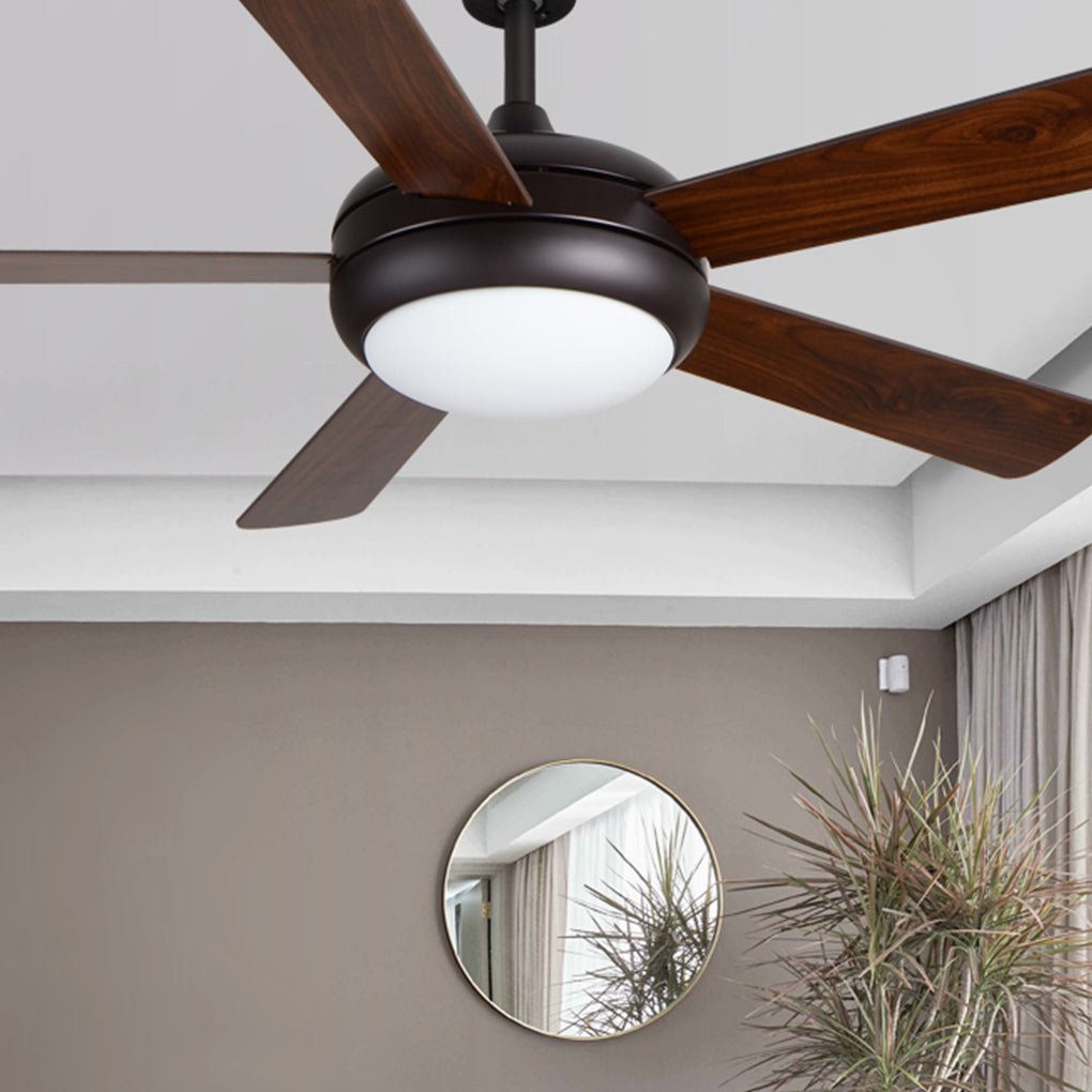 Semi-flush mount ceiling fan with light casting a warm glow in a cozy reading nook.