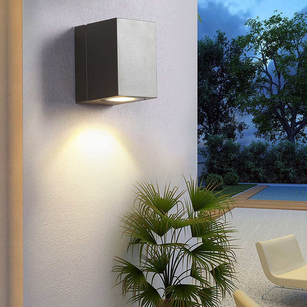 Sensor wall lights outdoor with a sleek black finish, mounted beside a potted plant.