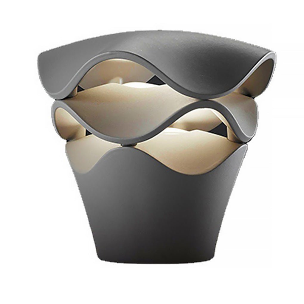 Short black wave design path light with compact tiered wave structure and warm LED light glow.