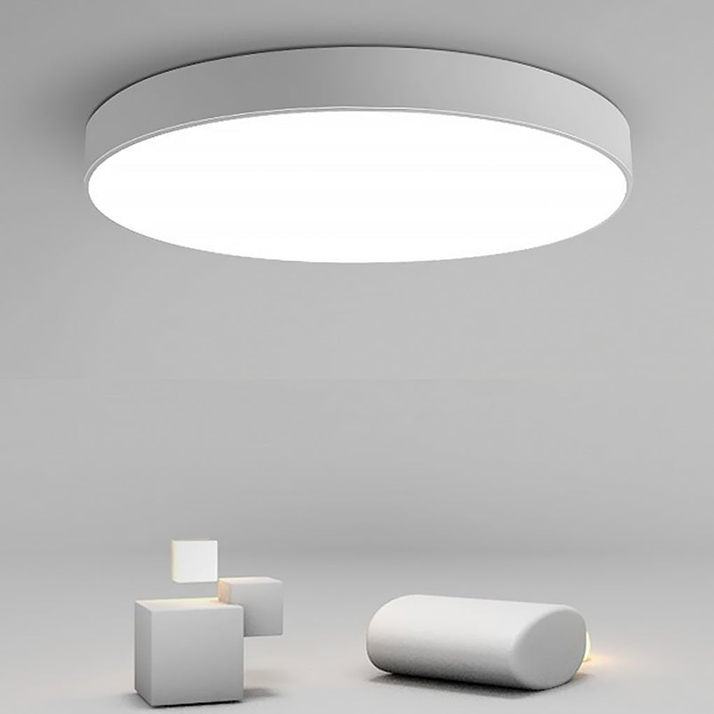 Simple flush mount ceiling light product display in minimalist studio setting.