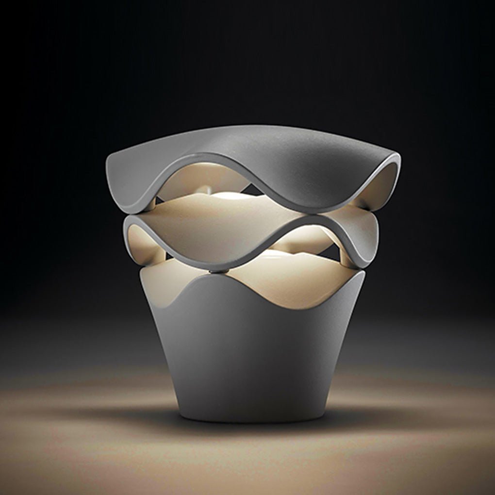 A single short wave design path light centered on a dark studio background with warm LED glowing