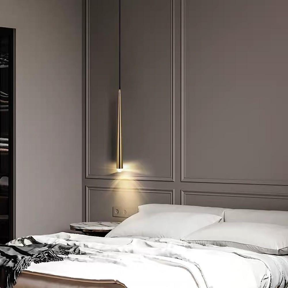 Sleek single Slim Gold Cone Pendant light hanging over a bedside table in a modern bedroom.