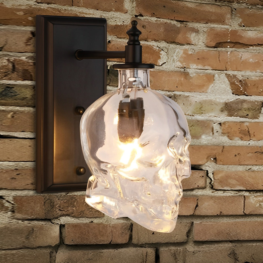 Artistic glass lamp shades for wall lights in skull form, mounted on a brick wall, casting a warm and inviting glow.