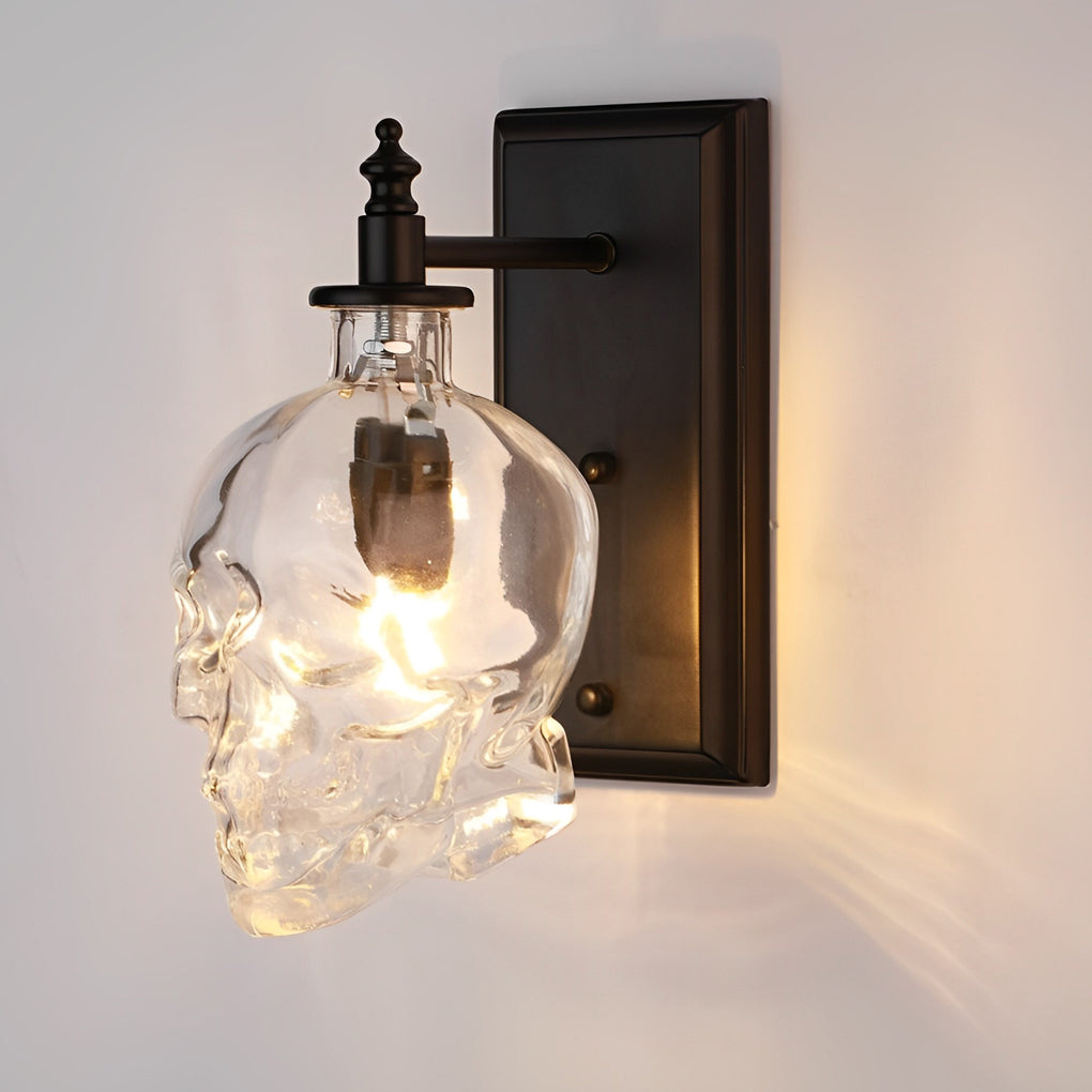 Close-up of glass lamp shades for wall lights in skull shape, showcasing intricate details and warm light emission.