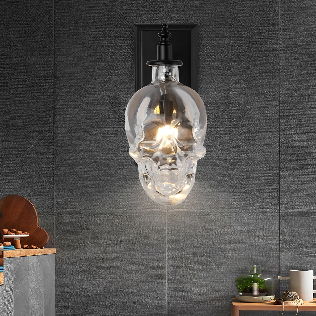 Modern glass lamp shades for wall lights with skull design, mounted on a textured wall, providing ambient indoor lighting.