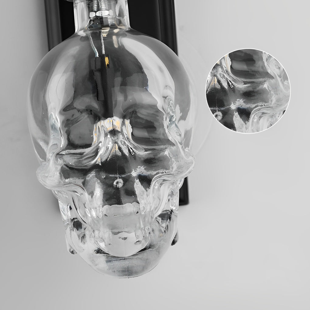 Detailed view of glass lamp shades for wall lights in skull form, emphasizing the transparent and artistic design.