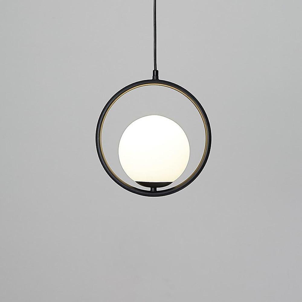 Sleek black circular pendant light with a glowing globe on a professional white background.