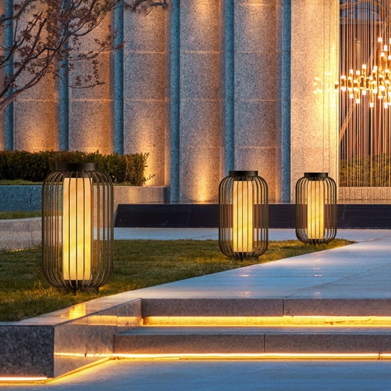 Lantern metal outdoor light with sleek black frame, installed beside pool steps for modern outdoor lighting.