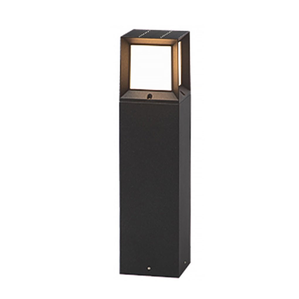 Sleek black outdoor bollard lights fixture illuminating warmly isolated on a clean white space.