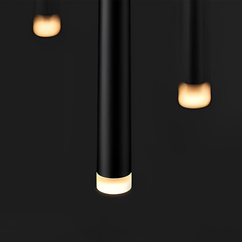 Detail of several Slim Black Pendant Light tubes with warm glowing ends on dark background.