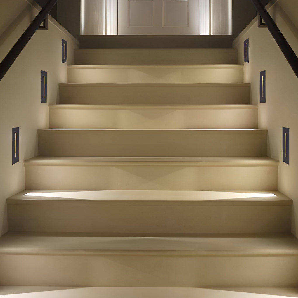 Slit stair lamp illuminating a minimalist staircase with focused glow.