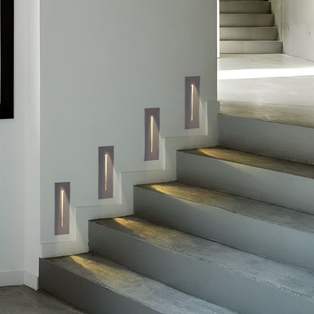 Slit stair lamp enhancing a modern staircase with warm light.