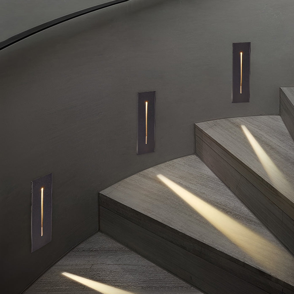 Slit stair lamp providing soft illumination along a stylish indoor staircase.
