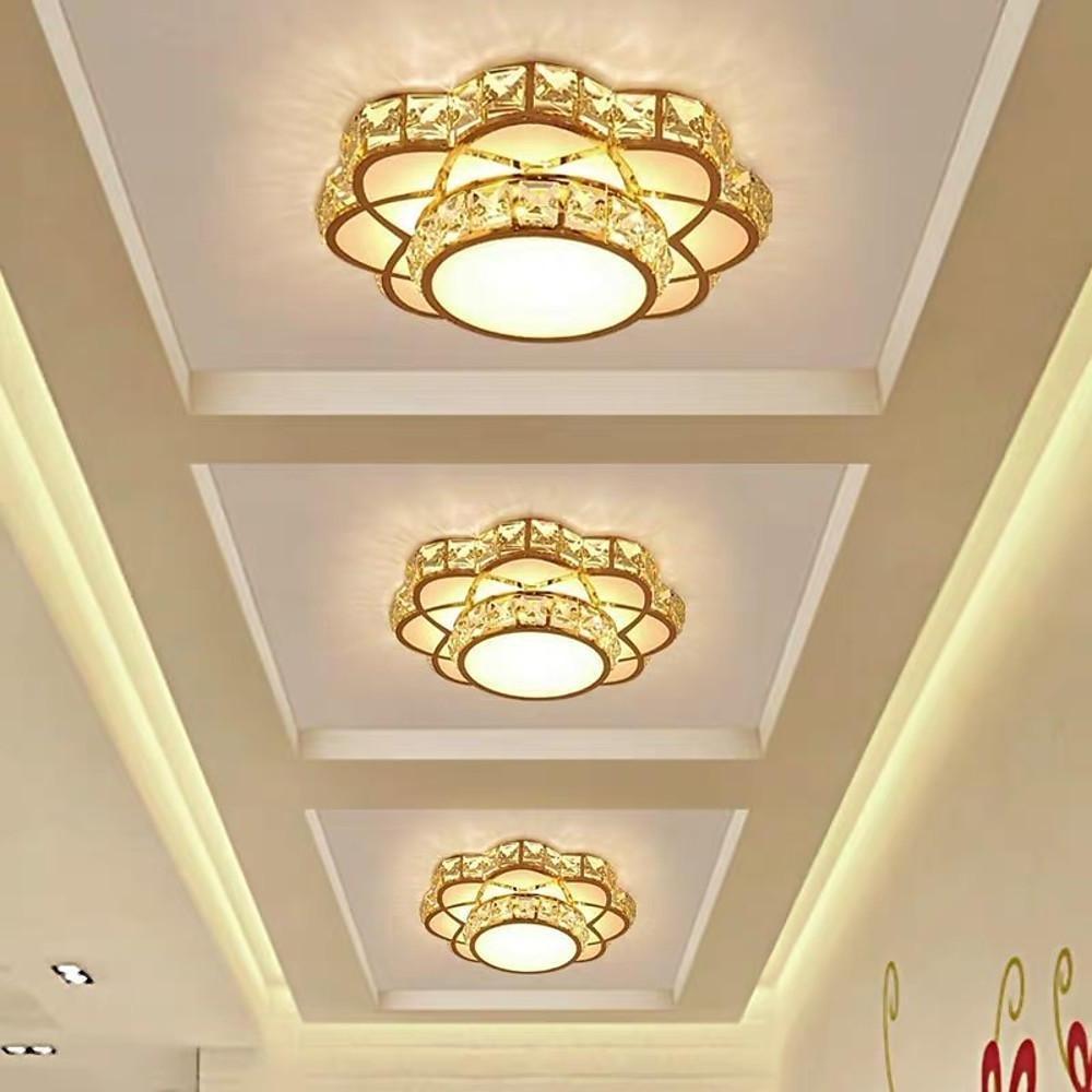 Small crystal flush mount ceiling light with a gold finish mounted on the ceiling.