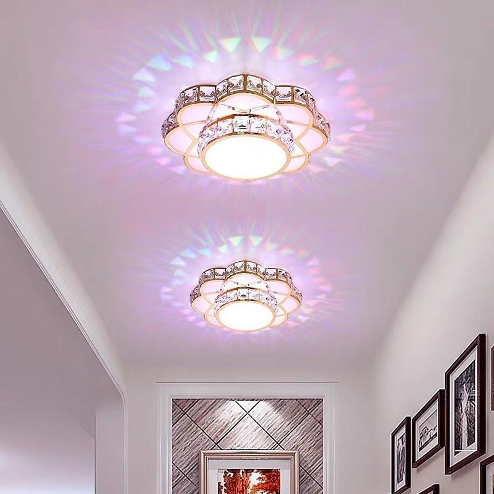 Small crystal flush mount ceiling light illuminating a narrow hallway space.