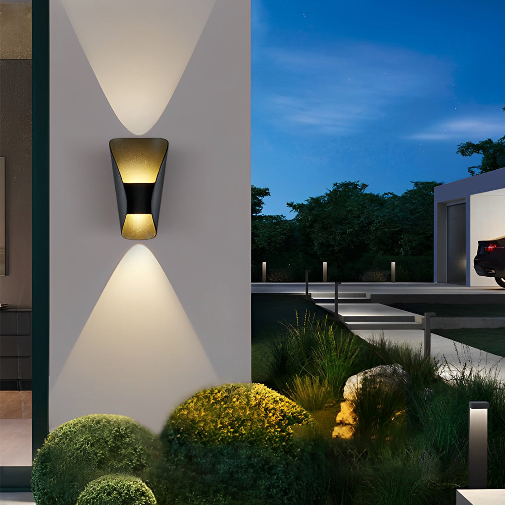 Small up down wall lights illuminating a contemporary patio with minimalist design.