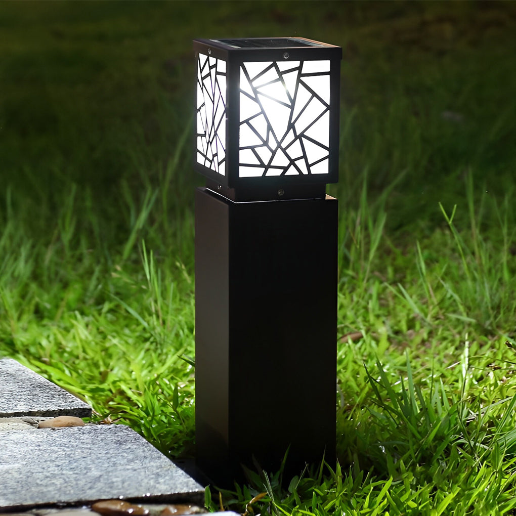 Solar bollard path lights illuminating a minimalist outdoor garden with focused glow.