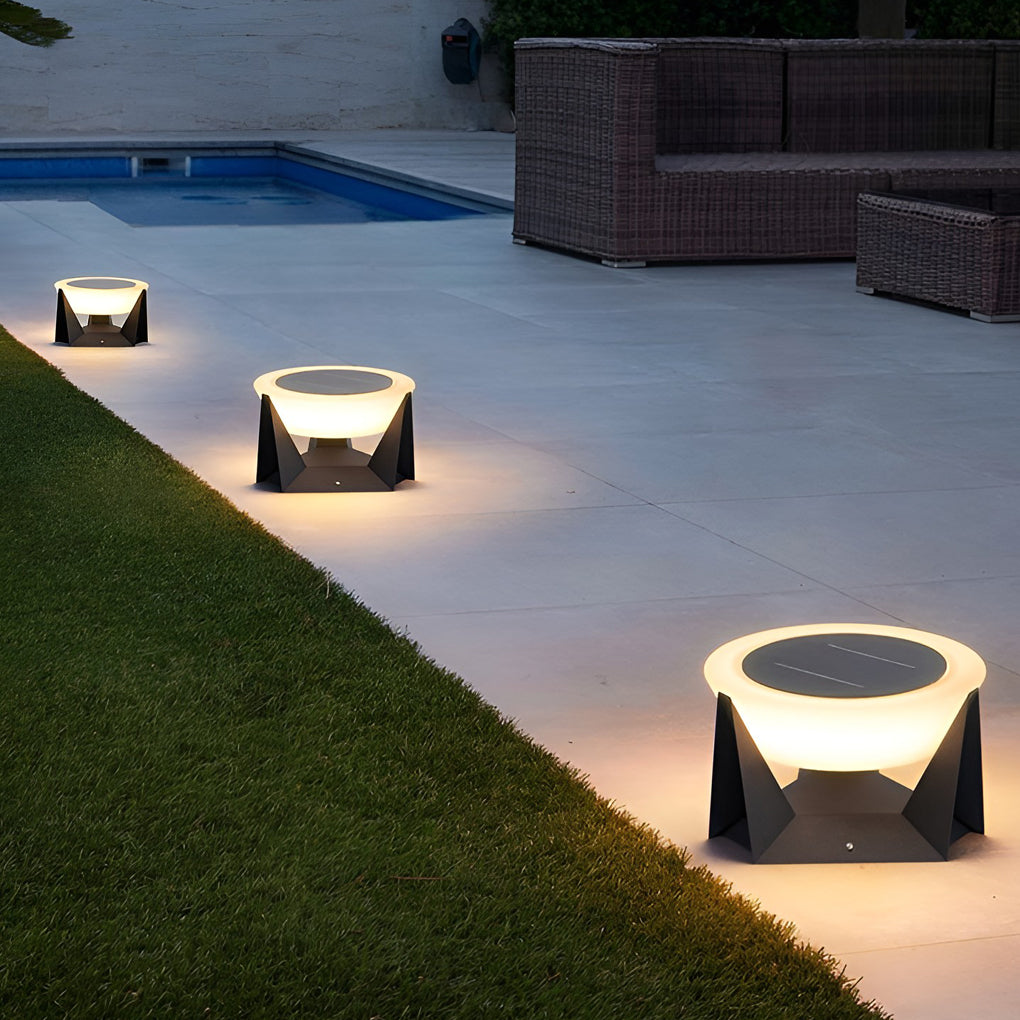 Solar fence pillar light arranged along a lawn edge, defining landscape borders at night.