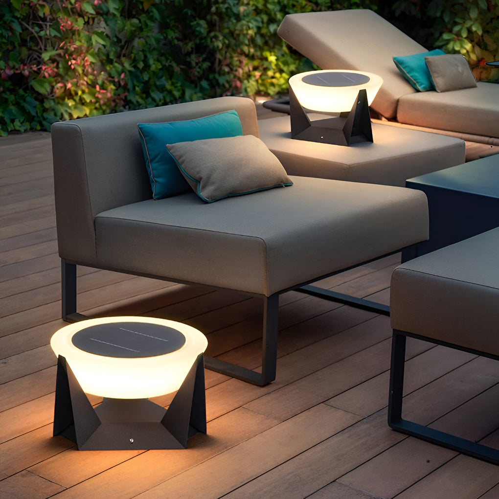 Solar fence pillar light beside outdoor lounge furniture, adding decorative illumination to the terrace.