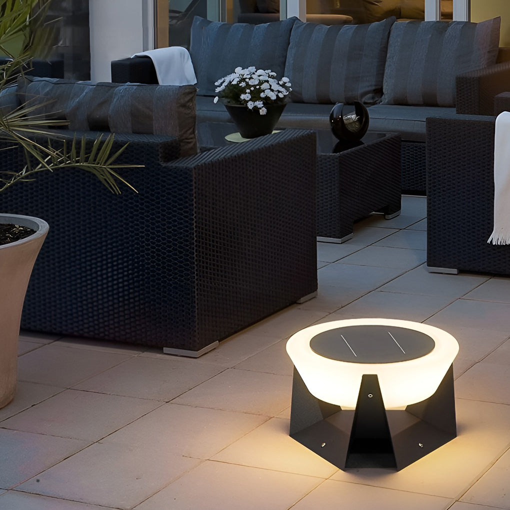 Solar fence pillar light positioned on a patio near outdoor seating, enhancing nighttime relaxation.
