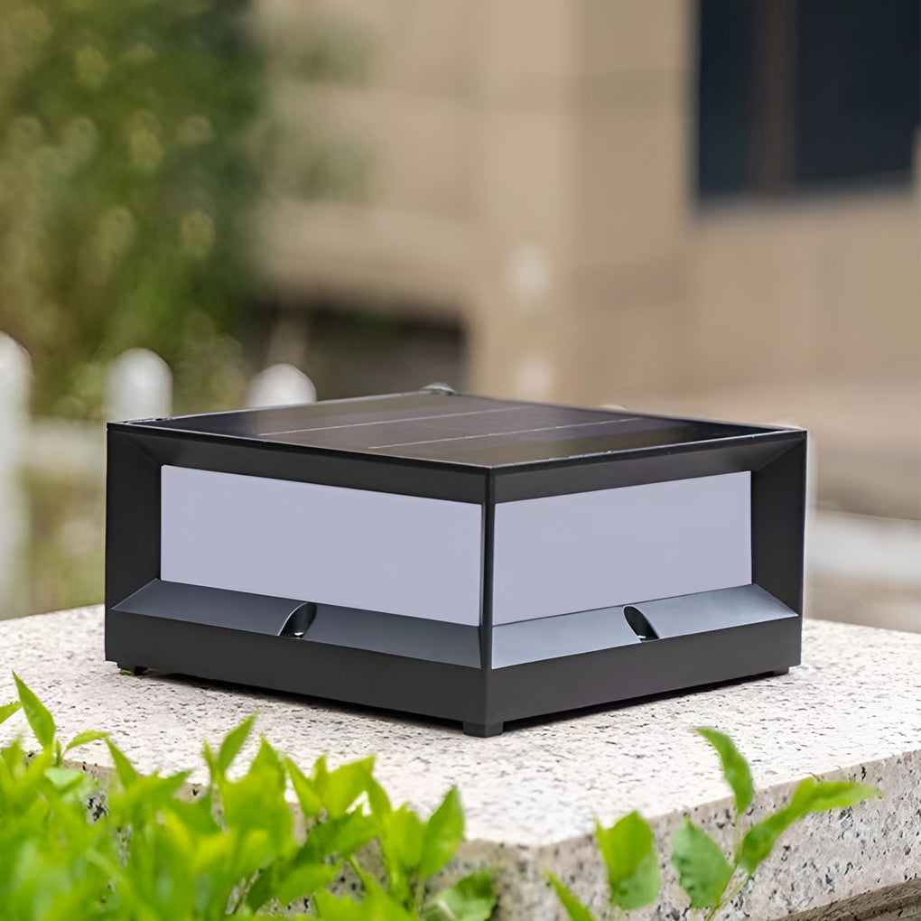 Solar garden pillar lights with black frame, installed on stone pillar near plants.