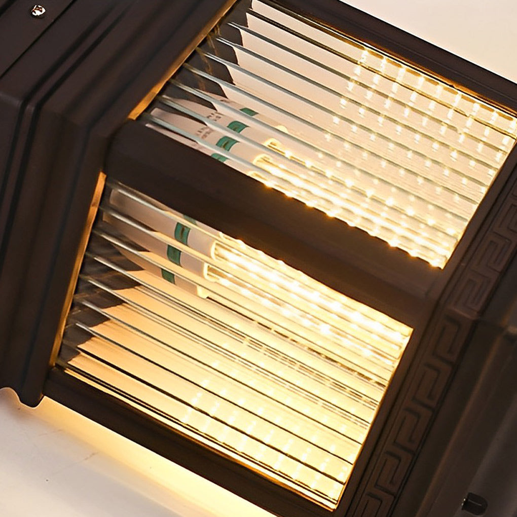 Solar garden post lights close-up showing ribbed glass panels and warm LED illumination inside the lantern.