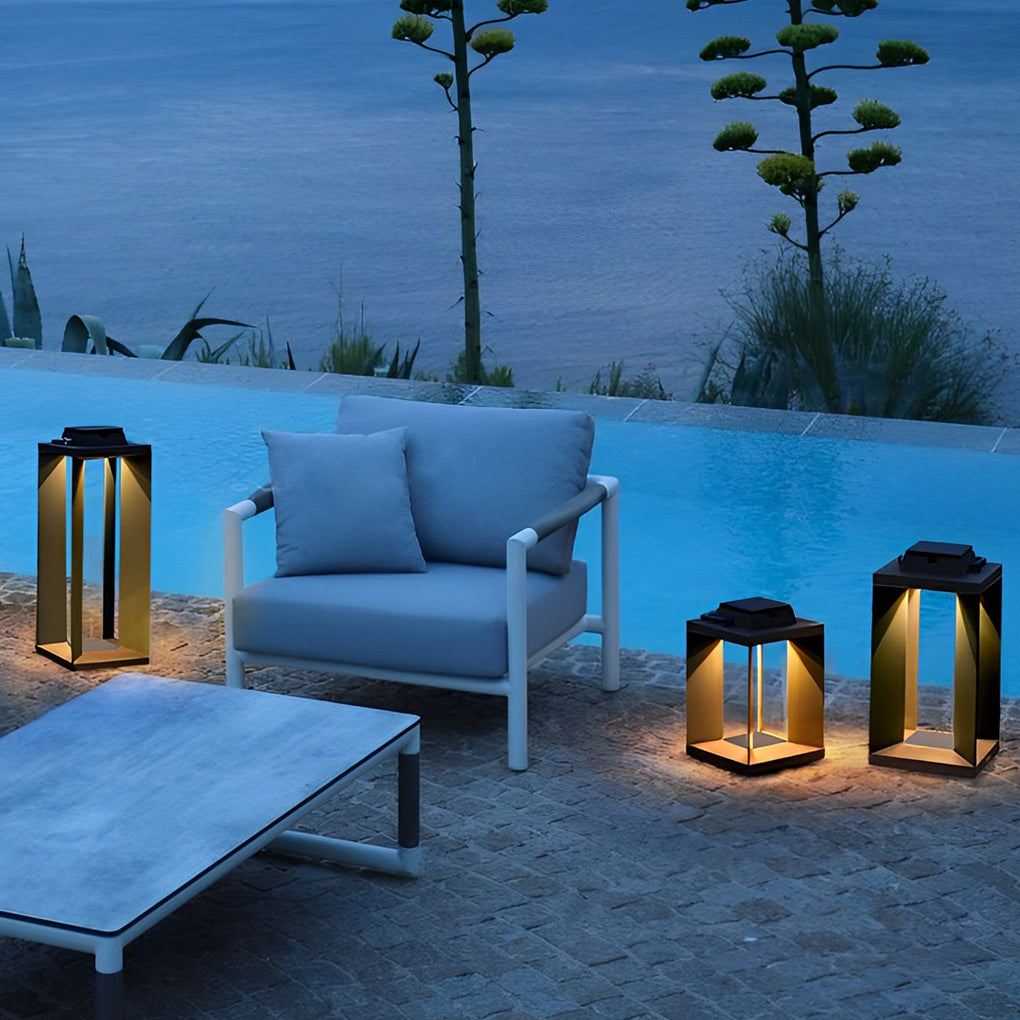 Multiple solar lanterns creating soft illumination around an outdoor seating area by the water.