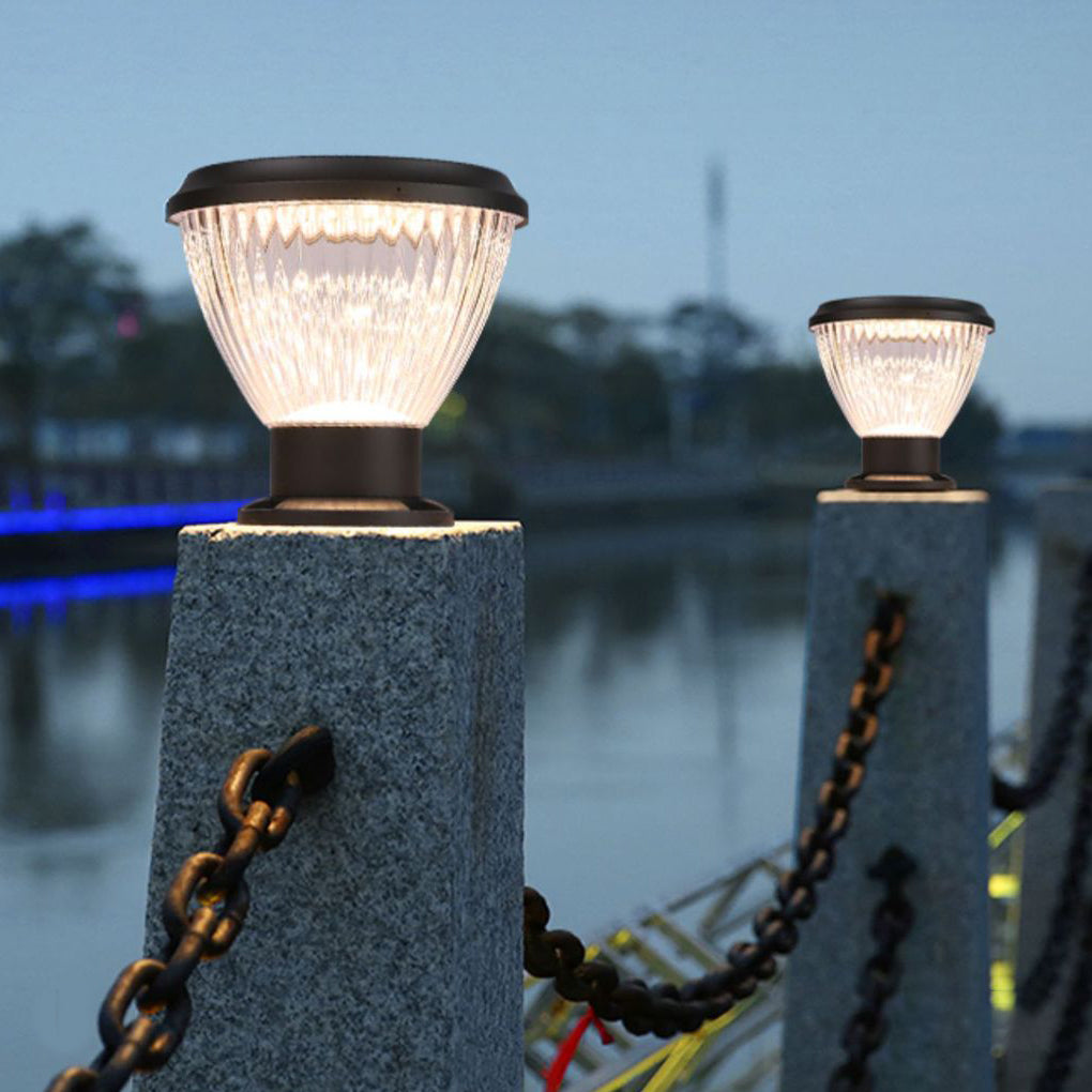 Solar light post cap providing soft illumination along a stylish waterfront pillar.