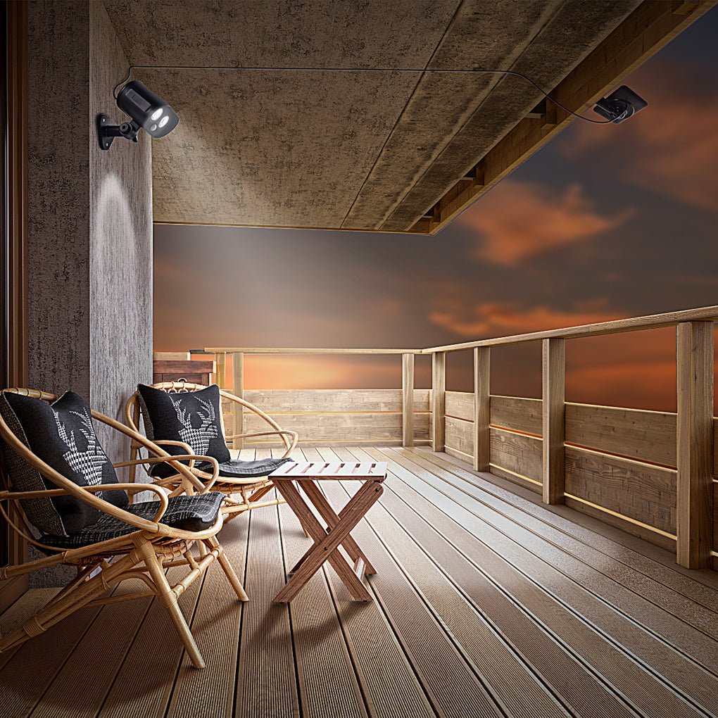Outdoor deck seating area illuminated by a solar motion sensor lamp under a covered patio.
