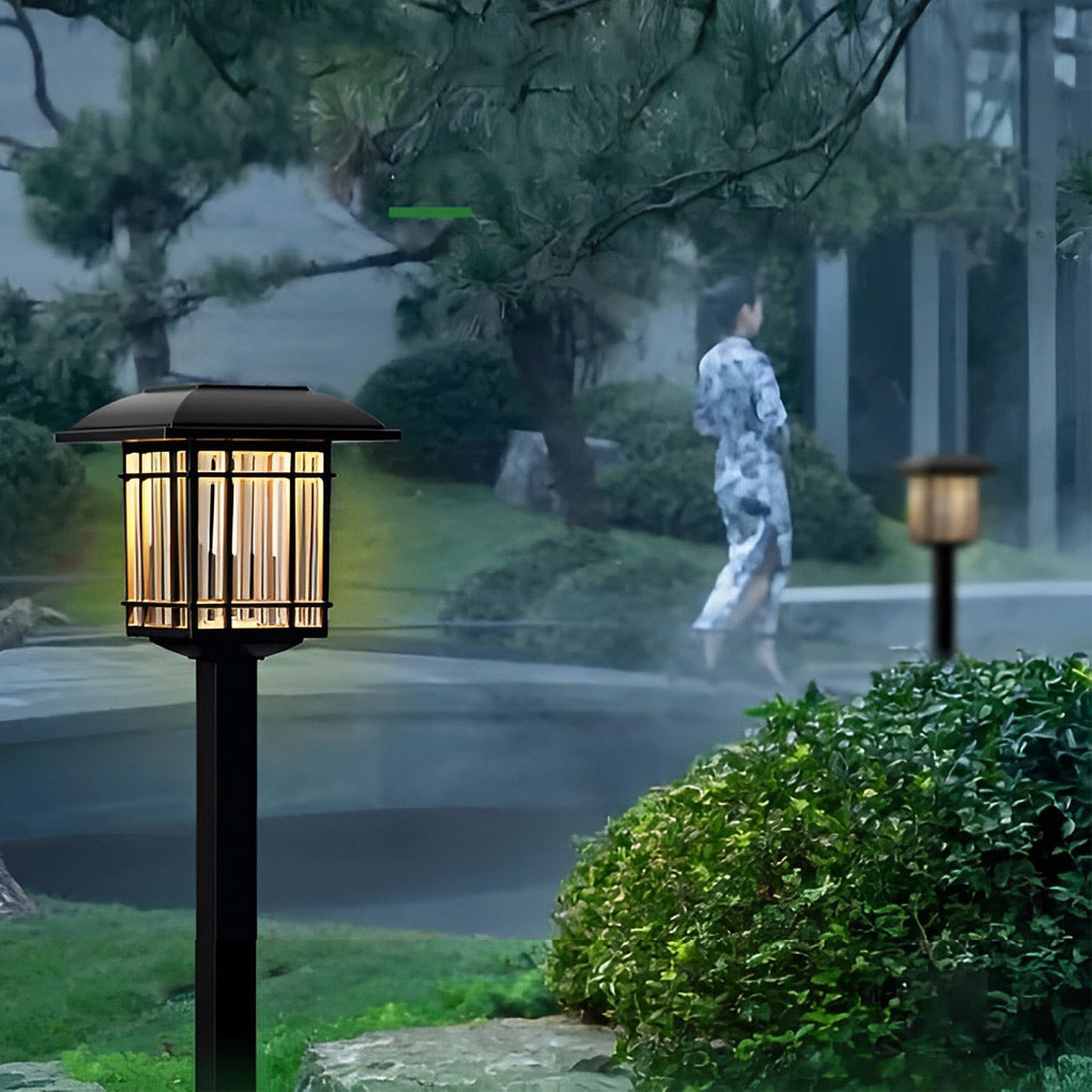 Solar outdoor lawn light with a modern black finish, enhancing a garden's ambiance.