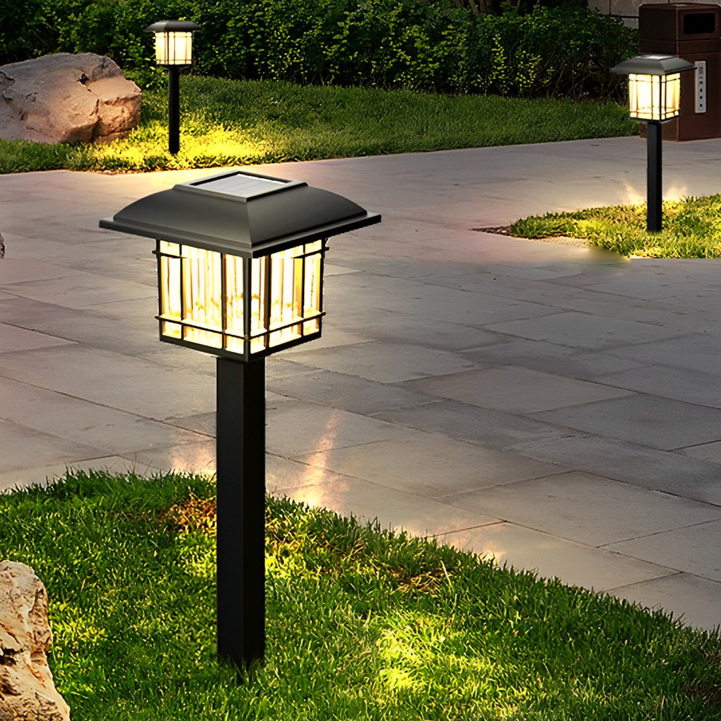 Solar outdoor lawn lights providing soft illumination along a curved garden walkway.