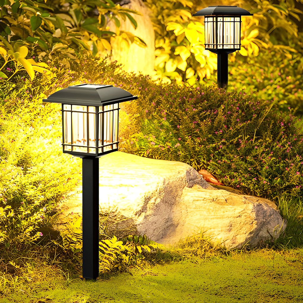 Solar outdoor lawn lights casting a gentle glow on a garden path surrounded by greenery.