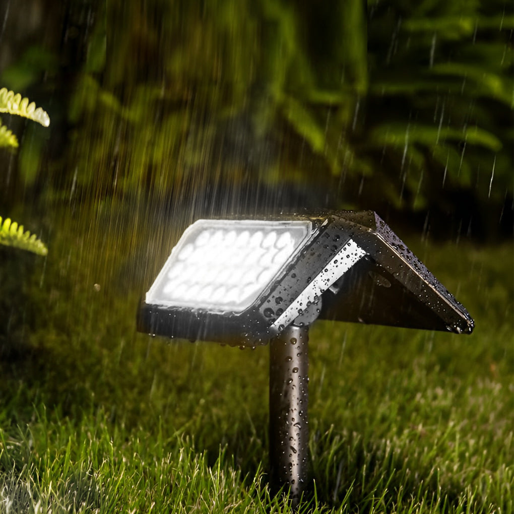 Solar path lights outdoor glowing brightly in the rain, ensuring visibility on a wet garden path.