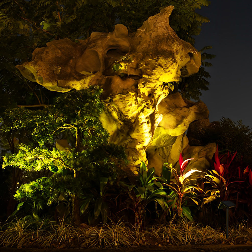 Solar path lights outdoor lighting up a well-maintained garden, showcasing vibrant foliage at night.