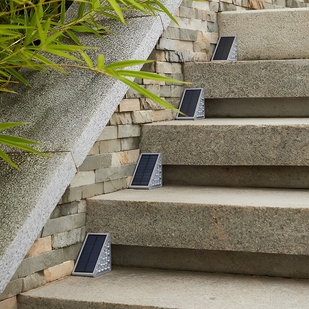 Compact solar powered lights for steps mounted on stone stairs, highlighting each step edge with soft illumination.
