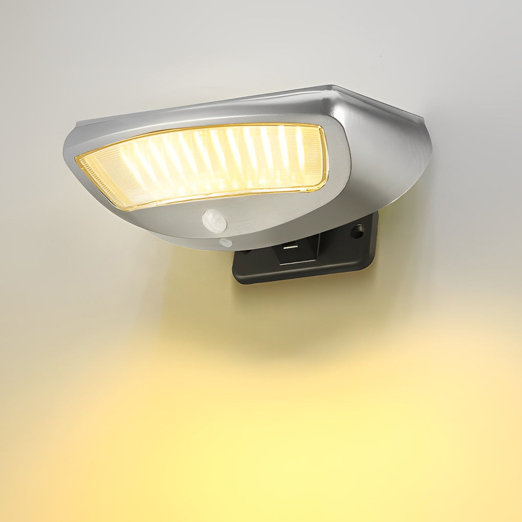 Solar powered motion sensor wall light providing bright light in a backyard setting.
