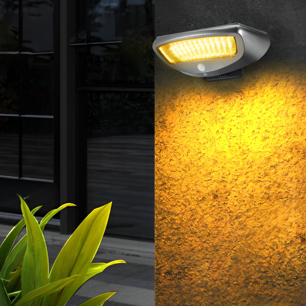 Solar powered motion sensor wall light providing bright illumination on a dark wall.