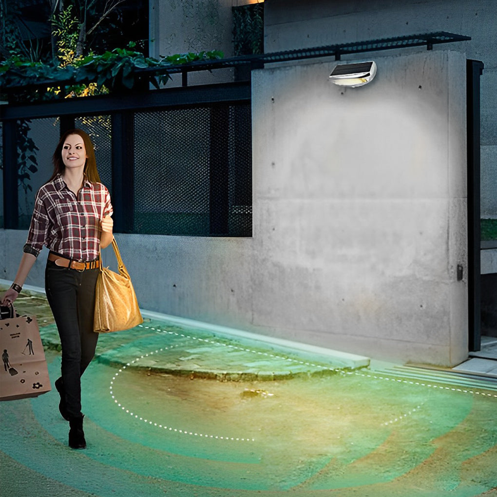 Solar powered motion sensor wall light with a modern design, installed near a garage.