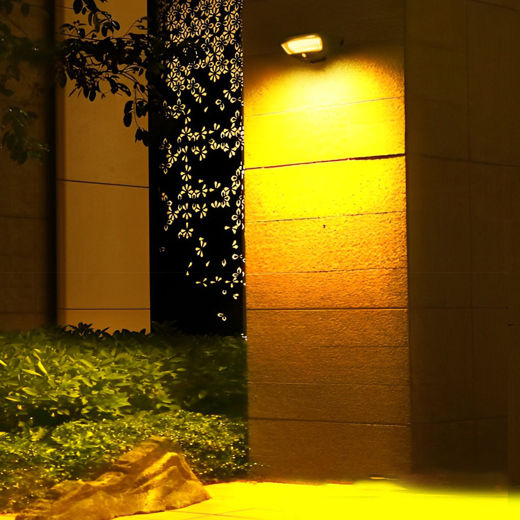 Solar powered motion sensor wall light providing security illumination for a driveway.