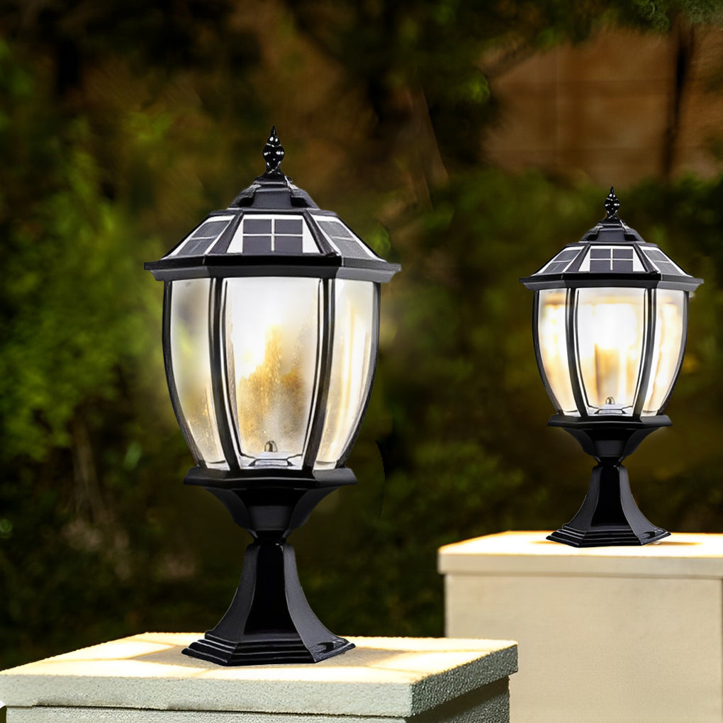 Solar powered pillar lights casting a gentle glow near a stone pillar.