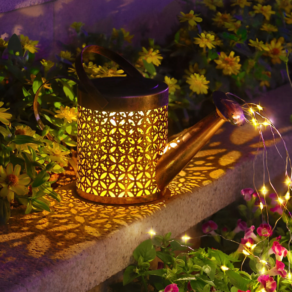 Close-up of a solar watering can light with an antique copper finish and perforated floral pattern.