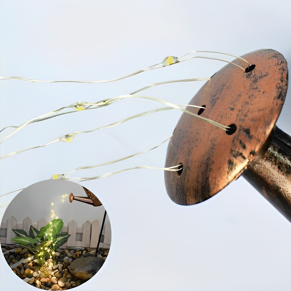 Close-up of cascading LED wire strands extending from the spout of a solar watering can light.