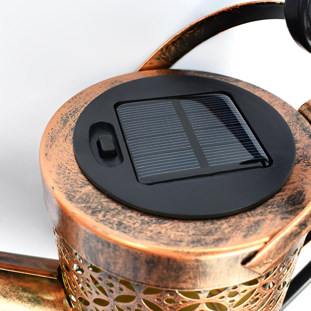 Close-up of the solar panel and power switch on a decorative watering can garden light.