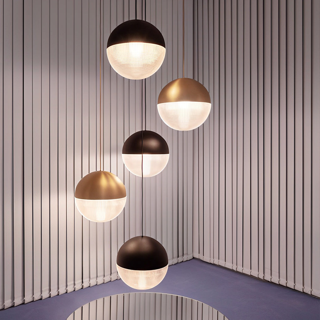 Modern spiral multi-light pendant cluster with mixed gold and black globes in a stylish room.