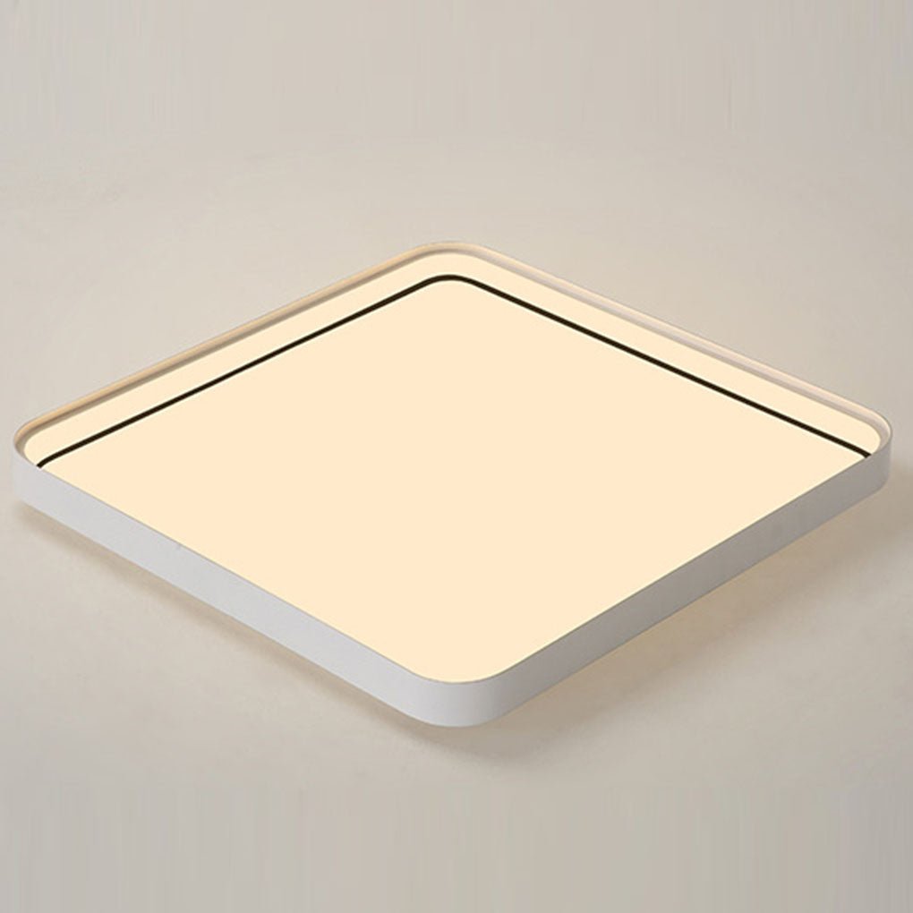 Square flush mount ceiling light close-up showing warm light panel surface.