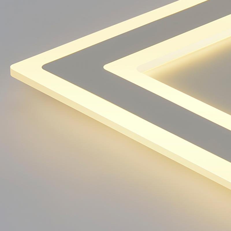 Square flush mount light with a modern design, providing soft light in a living room.