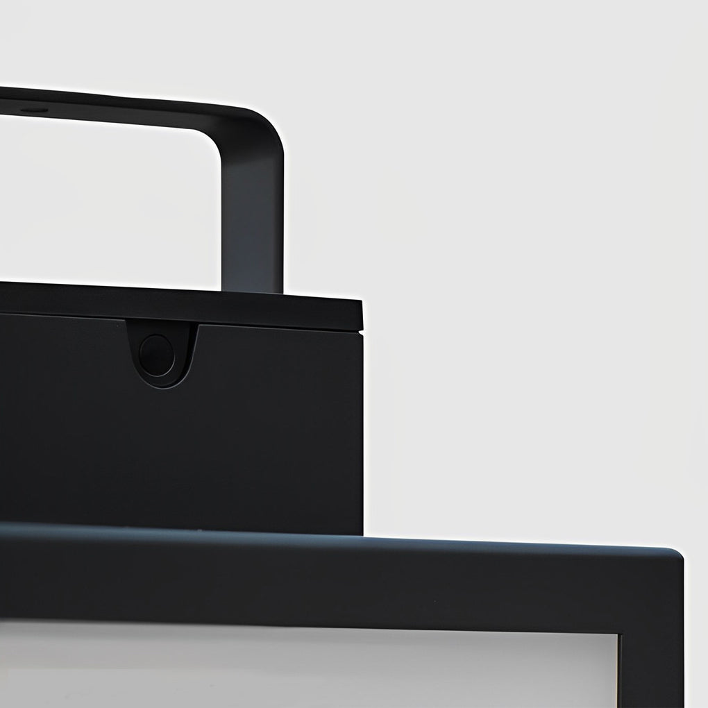 Square handheld lantern with black frame on outdoor table.